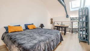 Un dormitorio con una cama grande, un escritorio y una ventana.