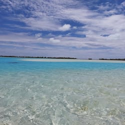 On the beach, white sand, sun-loungers