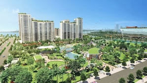A high-rise residential building complex with multiple floors, a central landscaped area with a pool, and a view of the sea. - New City Thu Thiem D2 (Ho Chi Minh City)