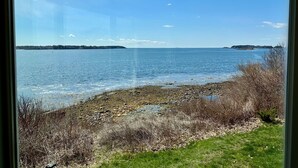 A view of a lake with a rocky shoreline and grassy areas. - Stunning Ocean Views, newly renovated cottage-close to preserves, trails, and Harpswell Beaches (Harpswell)
