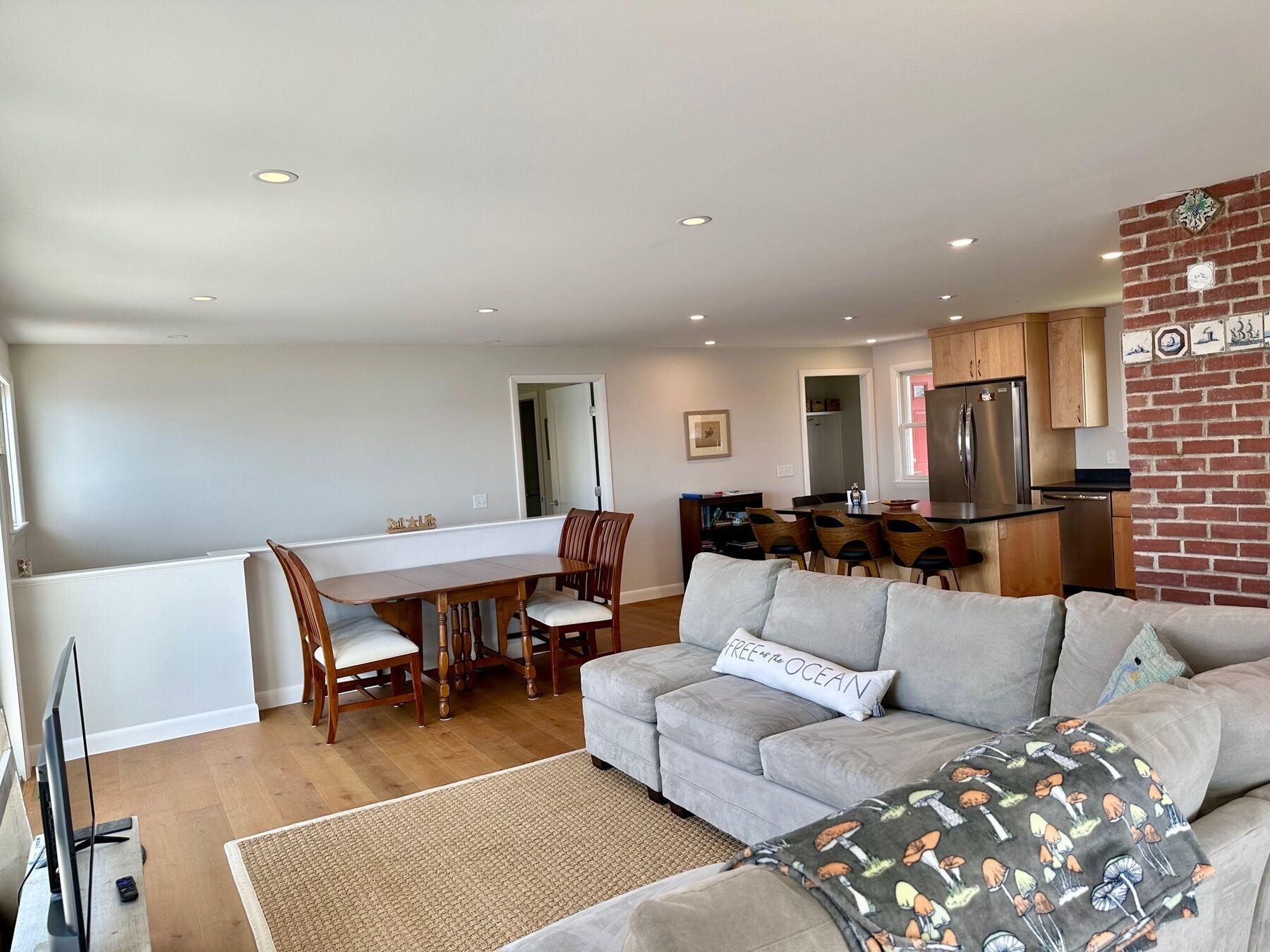 A modern apartment with a dining area, kitchen, and living room.