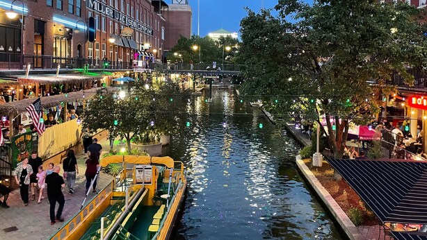 A riverside walkway with boats, restaurants, and a bridge. - 7BR Comfort Haven For 16 I Next to Tinker I EC (Midwest City)