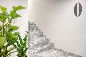 Stunning staircase flanked by lush greenery and elegant lighting.