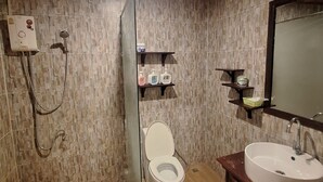 A bathroom with a toilet, a sink, and a shower. There are shelves with toiletries and a mirror above the sink. - LuangPrabang Pavilion Hotel & Travel (Luang Prabang)