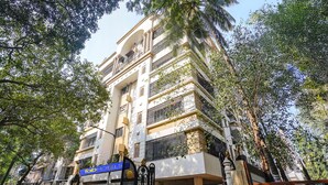 A multi-story hotel with balconies and a gated entrance. - Fabhotel Welcome Apartments (Mumbai)