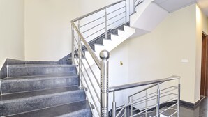 A modern staircase with metal railings and a handrail, leading to an upper floor. - Fabhotel Lfc (Jaipur)