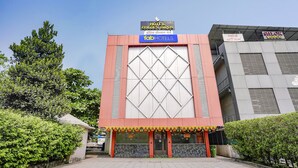 A hotel with a prominent sign for 'Golden Birds' and 'Fab Hotels'.
