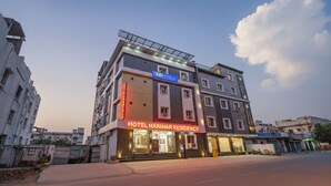 A multi-story hotel with a prominent sign for "Tab Hotels" and "Hotel Harivar Residency." - Fabhotel Hari Residency (Haridwar)