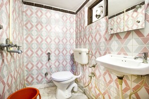 A bathroom with a toilet, sink, and shower. - Fabexpress City Inn (Faizabad)