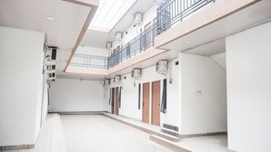 A spacious, multi-level interior with a high ceiling and skylights. - Hotel O Teluk Betung Near Water Park Lembah Hijau Formerly Kanajiwa Guesthouse 2 (Bandar Lampung)