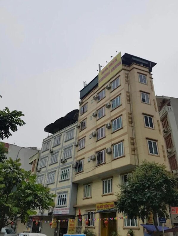 A multi-story building with a sign indicating it is a hotel. - Truong Giang Hotel HN - by BAY LUXURY (Hanoi)