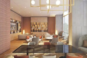 A modern lounge area with a glass table, comfortable seating, a bookshelf, and a large window. - The Antonia Apartments - Korea Town D7 (Ho Chi Minh City)