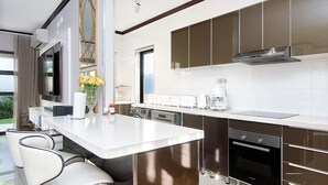 A modern kitchen with a large island, built-in appliances, and a view of the outdoors. - Craigavon House by Tanaka Kingdom  (Fourways)