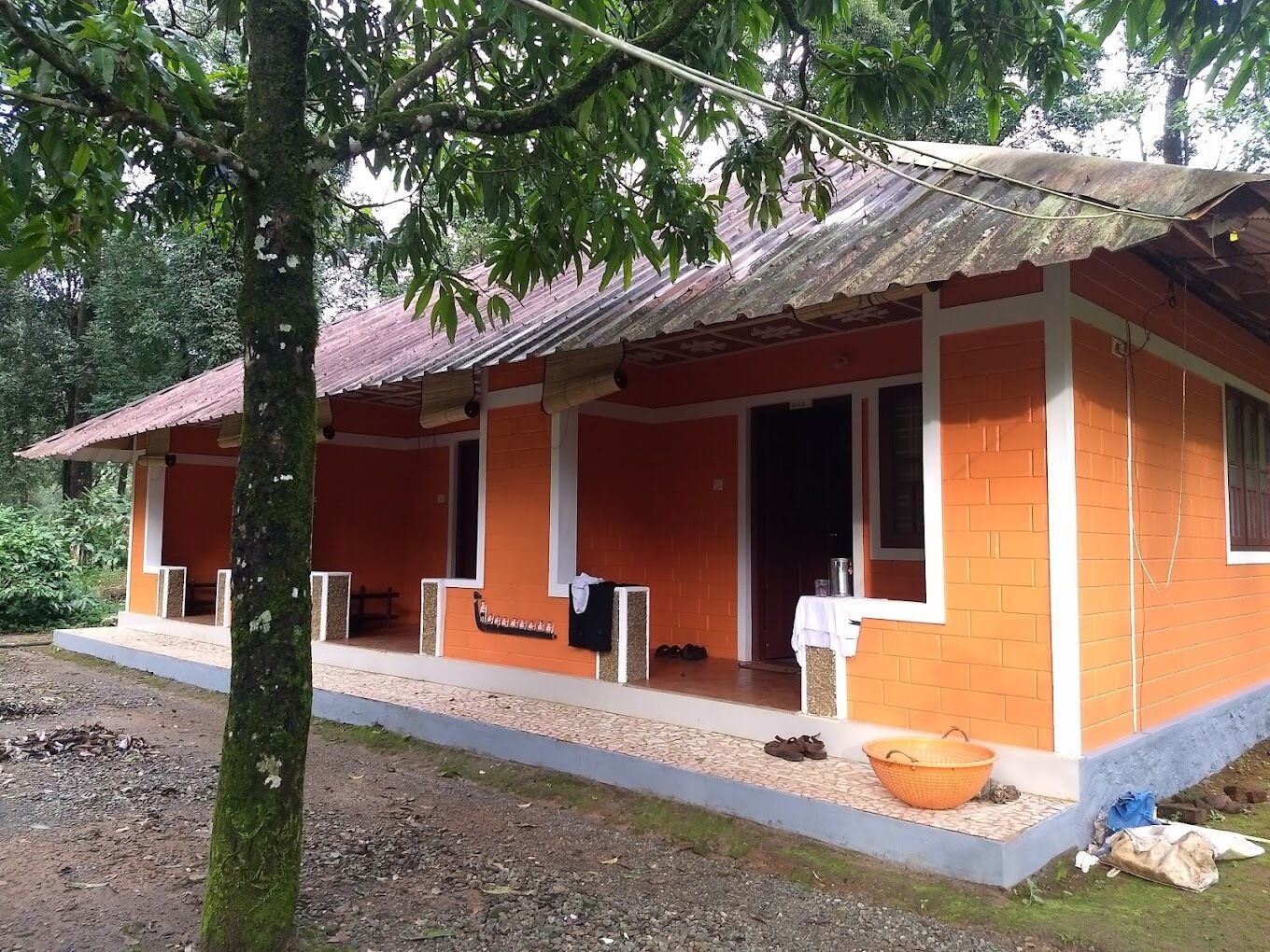 A single-story building with a corrugated metal roof and orange walls.