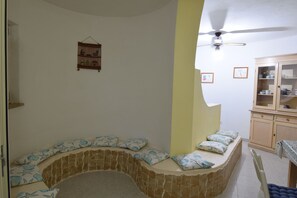 Apartment | Living area | 32-inch TV with cable channels, fireplace - Appartamento Tavernella In Budoni (Budoni)