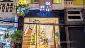 A hotel with a modern design, featuring multiple balconies and a prominent 'HOTEL' sign.