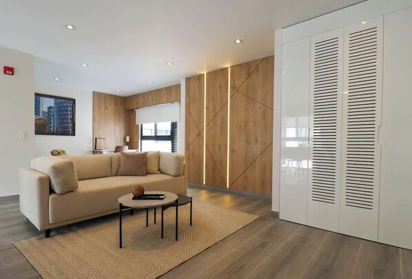 Relax in this stylish living space with a comfortable sofa, coffee table, and large window offering a view.