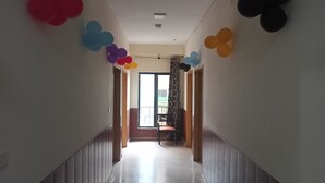 A hallway with wooden paneling and a view to a balcony. - Nest Hotel (Rawalpindi)