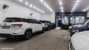 A parking garage with multiple cars parked in rows.