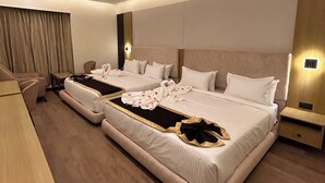A modern hotel room with a large bed, a desk, and a chair. - HOTEL OXINA CIIZEL (Kodaikanal)