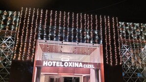 The entrance of HOTEL OXINA CIZEL with a modern facade and a prominent sign. - HOTEL OXINA CIIZEL (Kodaikanal)