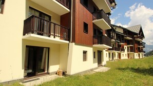 A row of modern multi-story buildings with balconies, likely part of a hotel or resort. - Large apt 6/8 ppl, direct slopes access, near center, terrace (Valfréjus)