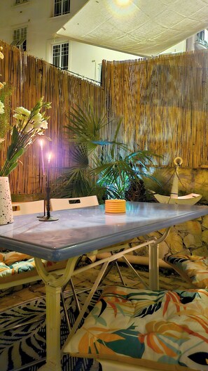 Relax in a stylish space with a large flat-screen TV, comfortable seating area, and a decorative plant arrangement.