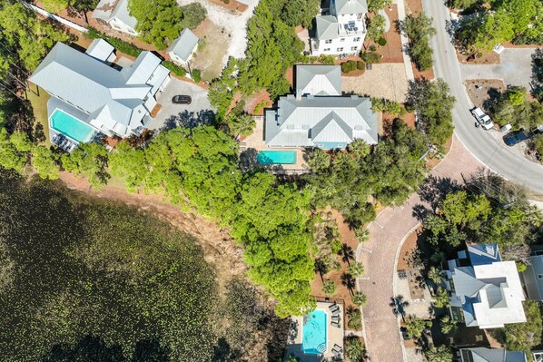An aerial view of a residential area with multiple houses, each featuring a swimming pool and surrounded by greenery. - Beach Escape w/ Private Pool & 5 Parking Spots (Santa Rosa Beach)