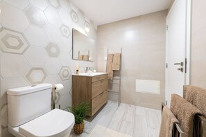 Shower, hair dryer, towels, toilet paper