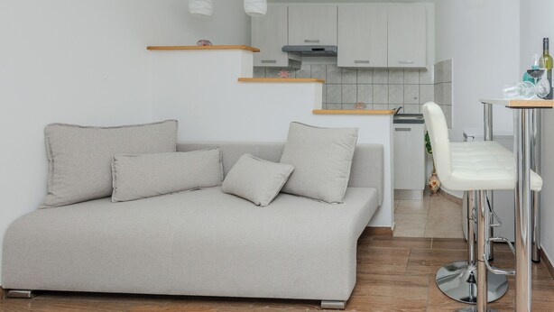 A modern living room with a sofa and a bar stool. - Holiday home Lucic (Nin)