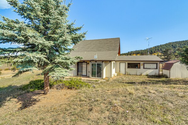 A single-story house with a sloped roof, a front door, and a small porch. - 5 Mi to Dtwn Evergreen: Mtn-view Escape (Evergreen)