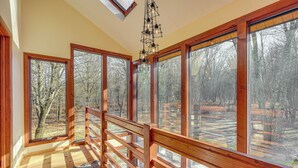 A room with large windows, wooden railings, and a skylight. - Ski, Hike & More: Spacious Log Cabin in Long Pond (Pocono Summit)