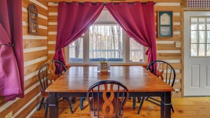 A wooden-paneled room with a dining table, chairs, and curtains. - Picnics & Bonfires: Rosedale Retreat! (Rosedale)