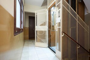 Staircase leads to a room with a door and window.