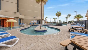 A pool area with lounge chairs and a palm tree. - Spacious Beachfront Condo at Sand Dunes Resort 1203 – Perfect Location with Top (Myrtle Beach)