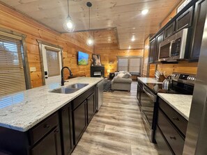 Fridge, microwave, oven, stovetop - Modern Smoky Mtn Cabin | Hot Tub | Game Room | 85" TV | Sunset Deck | Sleeps 11 (Sevierville)