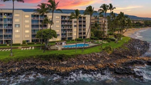 A hotel with multiple floors, a pool, and a view of the ocean. - Royal Mauian, #116^ 2 Bedroom Condo (Kihei)