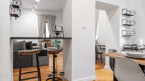 A modern apartment with a dining area, kitchen, and living space. - Apartment del Bello (Koper)