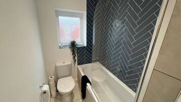 Combined shower/bathtub, deep-soaking bathtub, hair dryer, towels