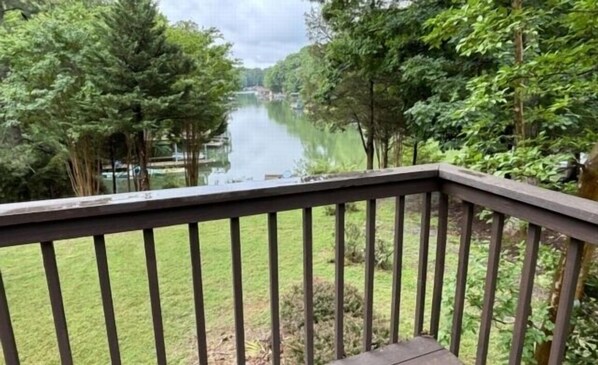 A view from a balcony overlooking a river, surrounded by trees and greenery. - Boats N Oats: Great family getaway, wifi, gentle lot, kayak (Moneta)