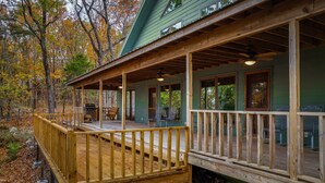 A wooden deck with a railing, a covered porch, and a grill area. - Snail’s Pace South-6br/3.5 bath w/gorgeous views (Fort Payne)