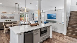 A modern kitchen with a central island, built-in appliances, and pendant lighting. - Beach🏖️Service! Rooftop Deck-Private Pool-LSV (Golf Cart)-Bikes🚲-8BR Palm Paradi (Miramar Beach)