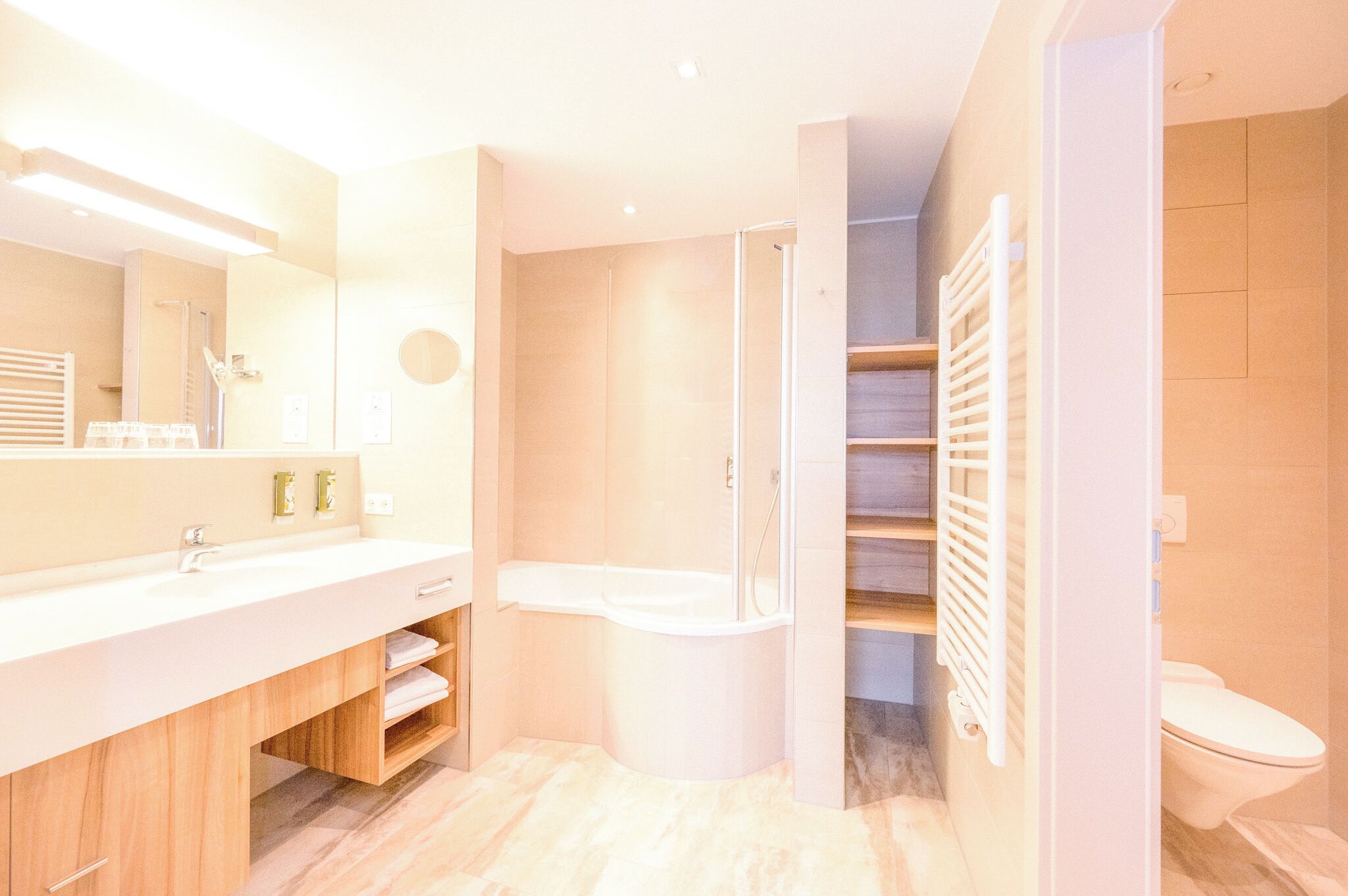 A modern bathroom with a shower, toilet, and vanity.