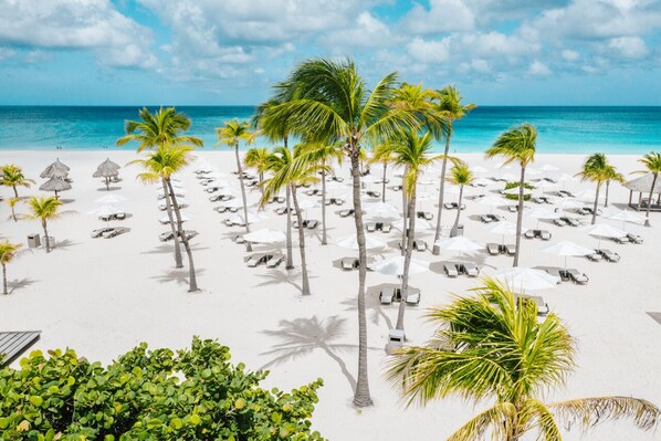 Vlak bij het strand, wit zand, vervoer van/naar het strand, parasols