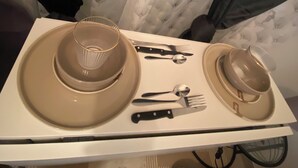 A dining table set with a plate, bowl, and cutlery. - Beautiful, quiet studio near Vichy (Saint-Rémy-en-Rollat)
