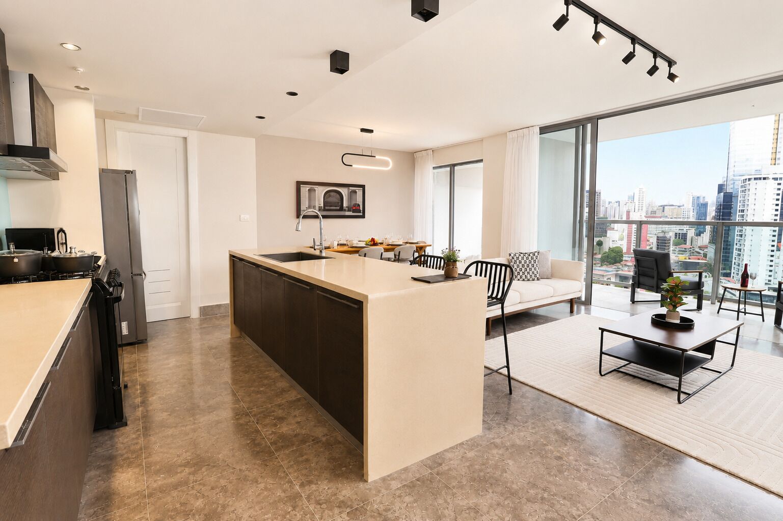 A modern kitchen with a central island, a dining area with a sofa and chairs, and a large window with a city view.