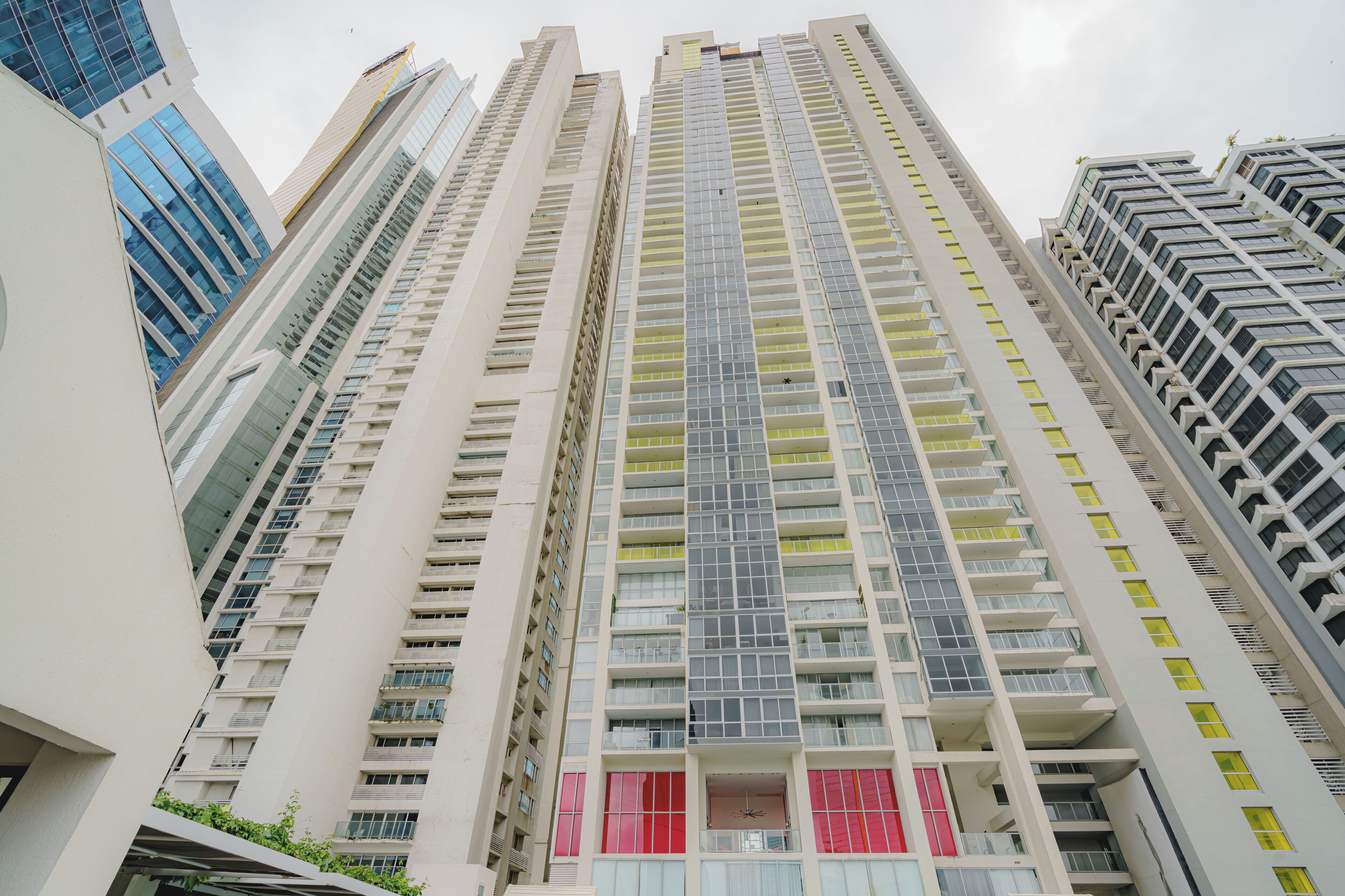 A high-rise building with multiple floors, large windows, and balconies.
