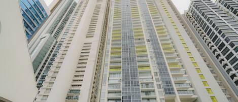 A high-rise building with multiple floors, large windows, and balconies.