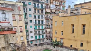 A courtyard with ancient ruins surrounded by modern buildings.