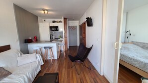 A compact hotel room with a kitchenette, a dining area, and a separate sleeping area. - Charming apartment 20 m from the beach in Arcachon (Arcachon)